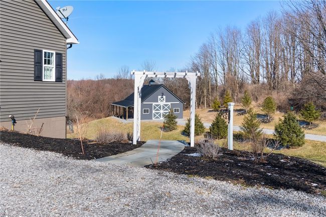 The walk to the rear patio and the pole barn | Image 30