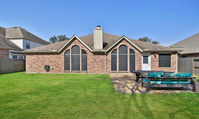 View of the back of the home and yard. | Image 18