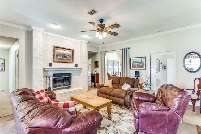 Hall on left leads to secondary bedrooms. Hall on right leads to master. Sunroom is through curtains and family room is through other door | Image 8