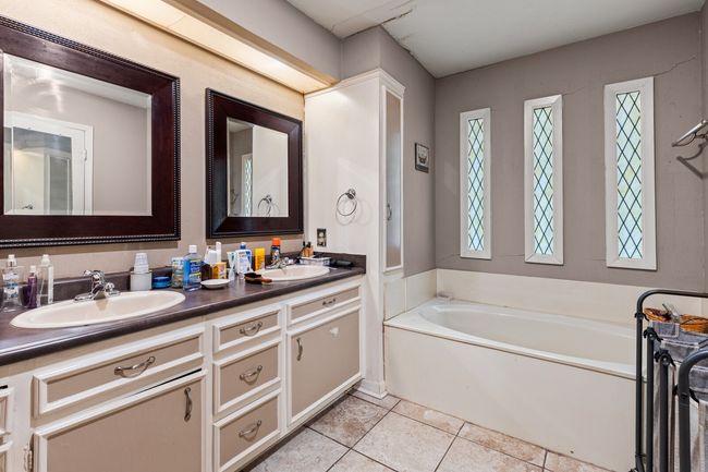 Full bathroom featuring a bath, tile patterned flooring, a sink, and double vanity | Image 19
