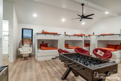 Interior space featuring lofted ceiling with beams, light hardwood / wood-style flooring, and ceiling fan | Image 1