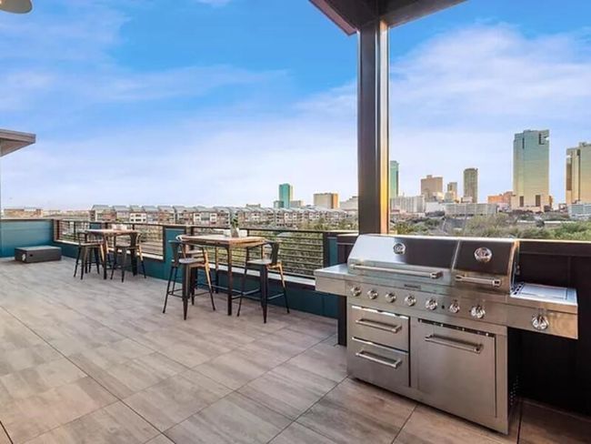 View of patio featuring an outdoor kitchen and a city view | Image 10
