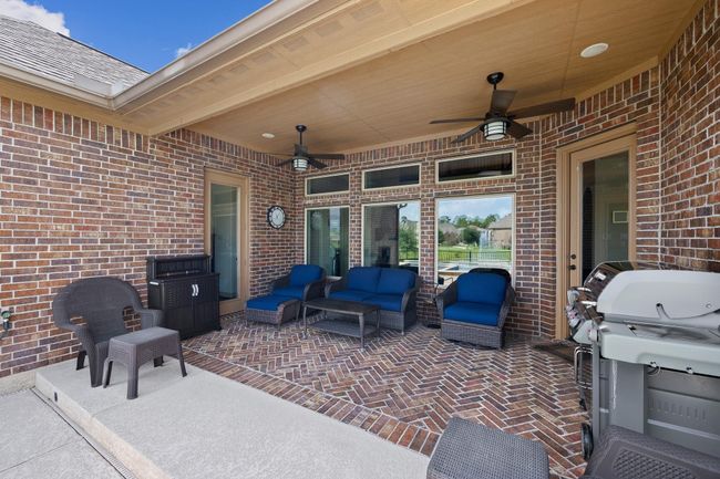 The covered back porch is the perfect place to enjoy some shade while taking in the view. | Image 40