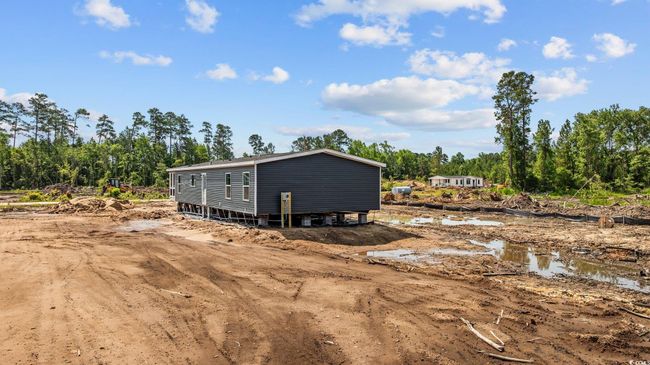 Rear view of property featuring view of wooded area | Image 32
