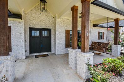 Strong, rich, wooden columns atop stone pedestals add a kind of rustic, ranchy elegance to the stunning, yet lovingly lazy view, with recessed front entry and extended covered porch comfortably sharing space. Inside, are 4 bedrooms, 2-1/2 baths, occupying a generous 10, 764 square-foot-lot with 2, 480 square-feet of incredible interior living space. | Image 3