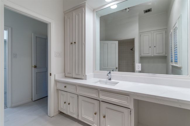 Full bathroom featuring vanity, a shower, and baseboards | Image 21
