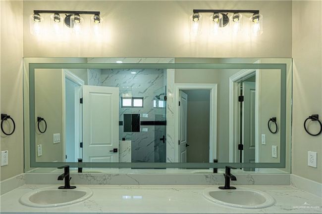 Bathroom featuring vanity and a marble finish shower | Image 21