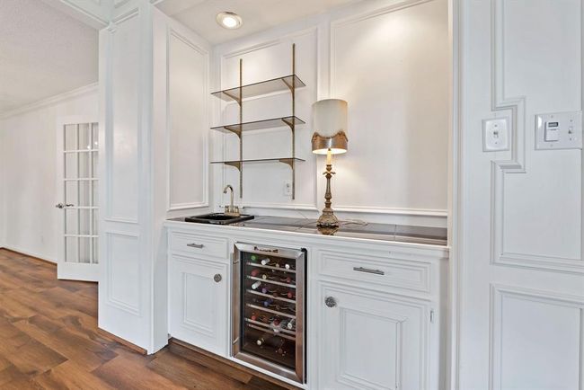 Bar area has wine cooler and sink, plus ample storage for all of your serving ware. | Image 6