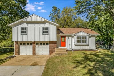 View of front facade with a garage and a front yard | Image 1