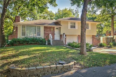 Tri-level home featuring a garage and a front lawn | Image 2