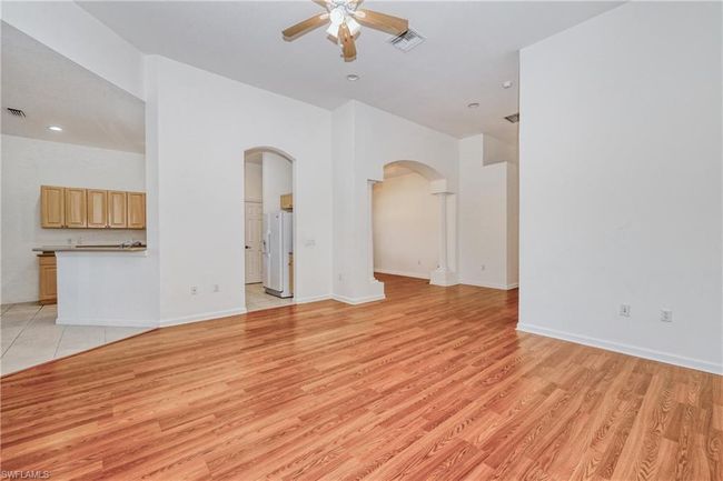 Unfurnished living room featuring ceiling fan and light hardwood / wood-style floors | Image 23
