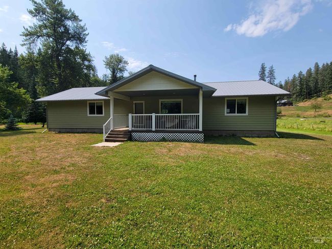 View of front of property with covered porch, a metal roof, and a front lawn | Image 25