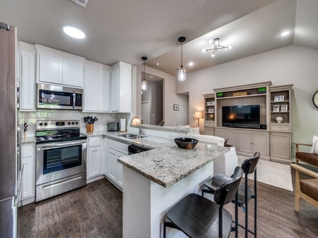 Kitchen featuring stainless steel appliances, a sink, a peninsula, open floor plan, and recessed lighting | Image 10