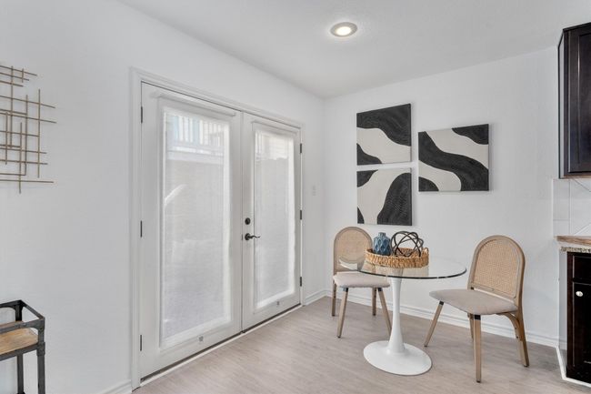 The breakfast area offers a cozy space to enjoy meals, seamlessly connecting to the kitchen and the private deck. | Image 11