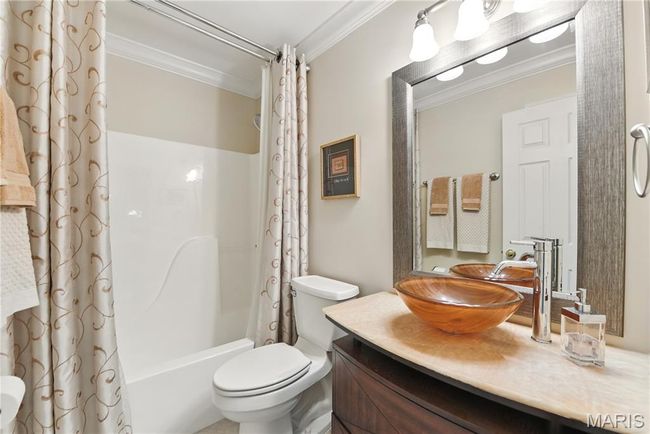 Bathroom with ornamental molding, shower / bathtub combination with curtain, and vanity | Image 14