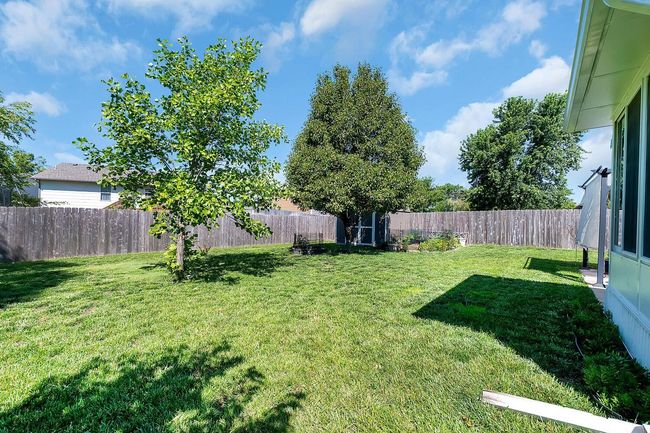 View of fenced backyard | Image 6