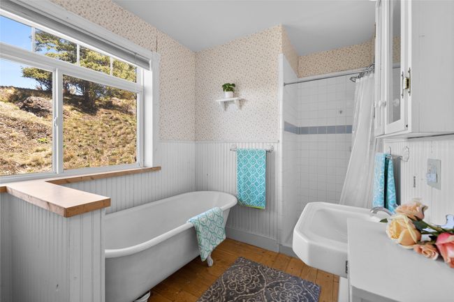 Bathroom featuring wainscoting, hardwood / wood-style floors, and wallpapered walls | Image 20