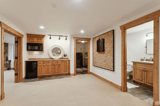 Laundry area with light carpet, baseboards, and recessed lighting | Image 43