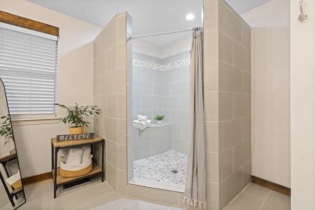 Full bath featuring tiled shower, tile patterned floors, and recessed lighting | Image 13