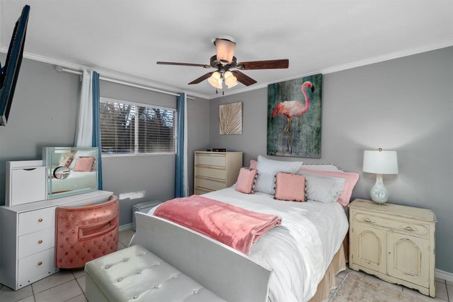 Full bedroom with tile floors and ceiling fan | Image 5