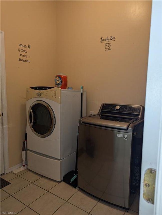 Washroom featuring washing machine and dryer and light tile patterned flooring | Image 16