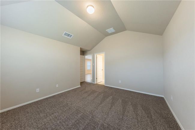 Empty room featuring carpet flooring, lofted ceiling, and baseboards | Image 10