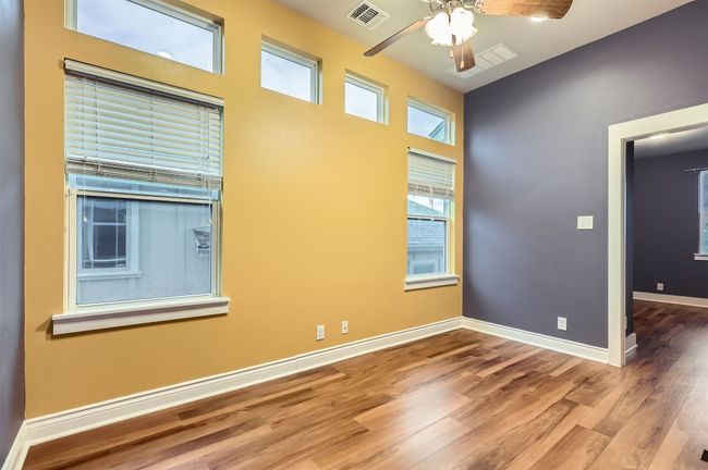 Spare room with a ceiling fan and wood finished floors | Image 22