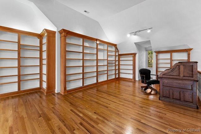 Home office with vaulted ceiling, wood finished floors, and rail lighting | Image 39