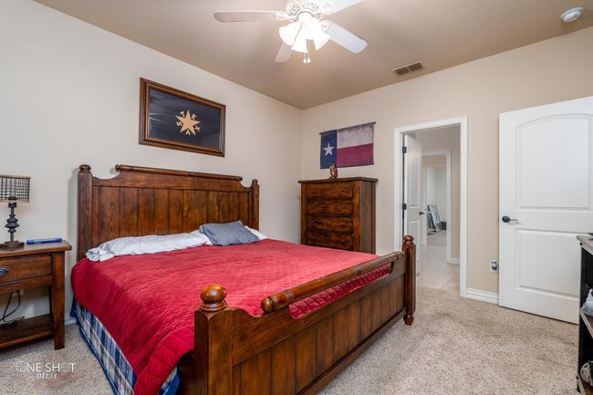 Bedroom with light carpet, baseboards, and ceiling fan | Image 27