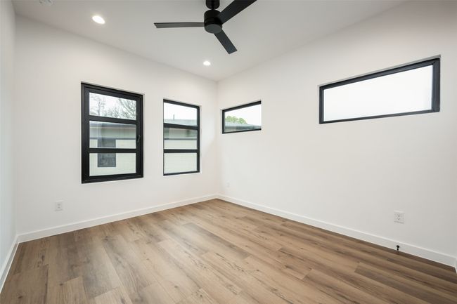 Empty room with ceiling fan, wood finished floors, and recessed lighting | Image 29