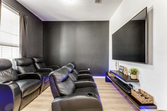 Home theater featuring light wood finished floors | Image 6