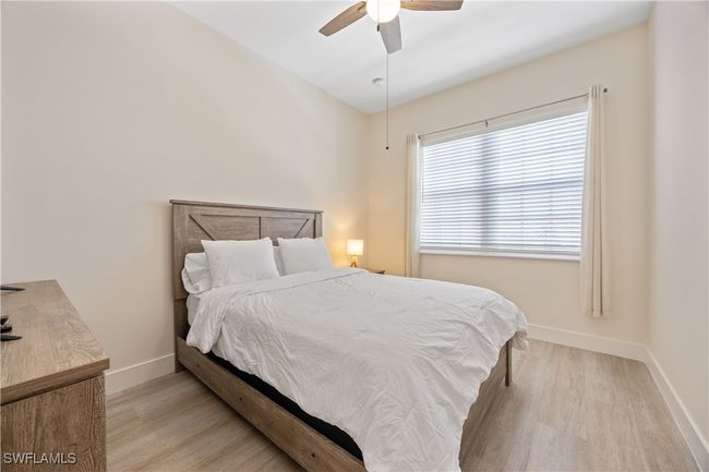 Bedroom featuring baseboards, a ceiling fan, and wood finished floors | Image 6