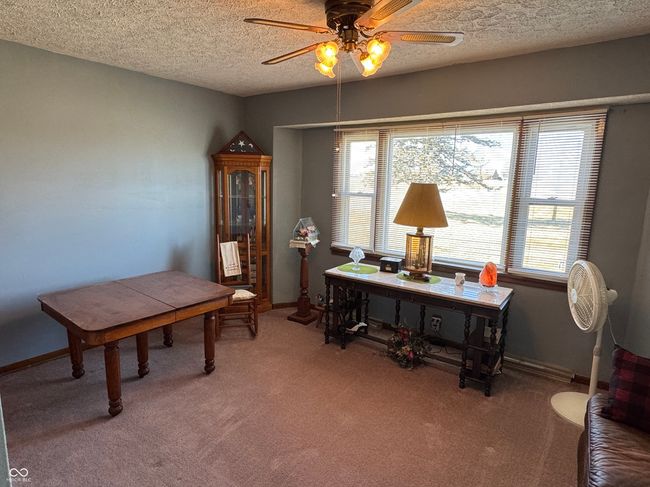 office area featuring baseboards, light colored carpet, and ceiling fan | Image 19
