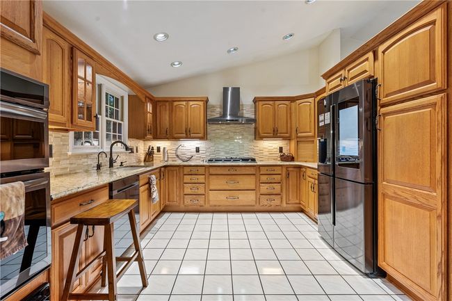 Updated Kitchen with Samsung Appliances, Cambria quartz countertops and stone backsplash. | Image 9