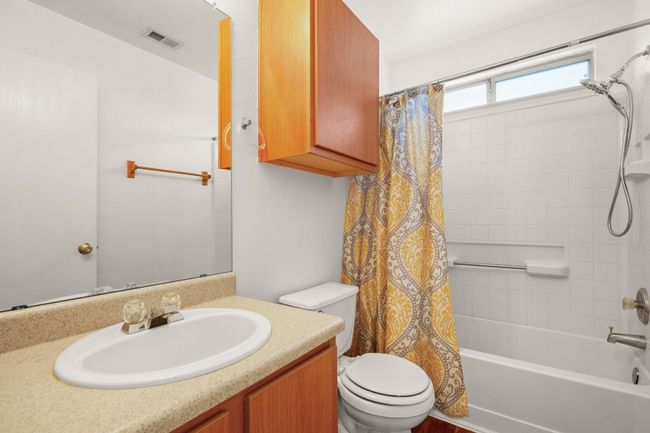 Shared full bath featuring shower / tub combo and vanity | Image 20