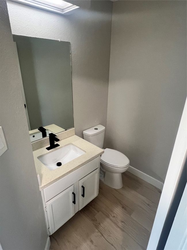 Half bath with wood finished floors and vanity | Image 16