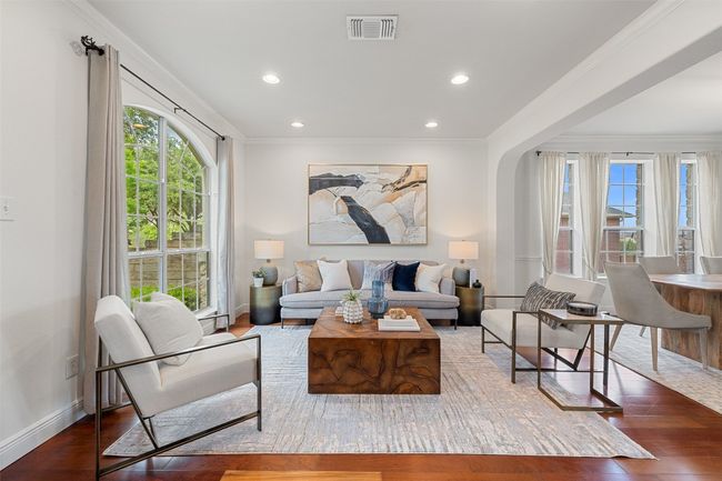Living area featuring crown molding, wood finished floors, healthy amount of natural light, and recessed lighting | Image 7