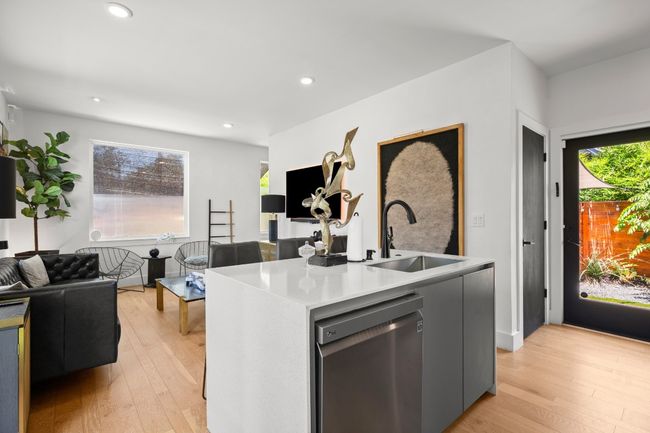 Kitchen featuring dishwasher, light wood finished floors, open floor plan, healthy amount of natural light, and recessed lighting | Image 12