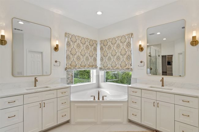 Full bath with a stall shower, tile patterned floors, a bath, and a sink | Image 14
