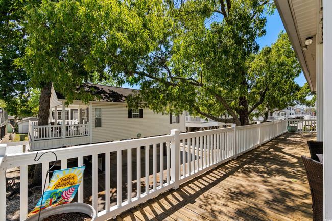 Wooden deck featuring an outdoor living space, a ceiling fan, and outdoor dining space | Image 13