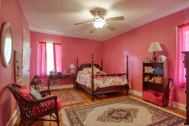 Bedroom featuring wood finished floors, baseboards, and ceiling fan | Image 22