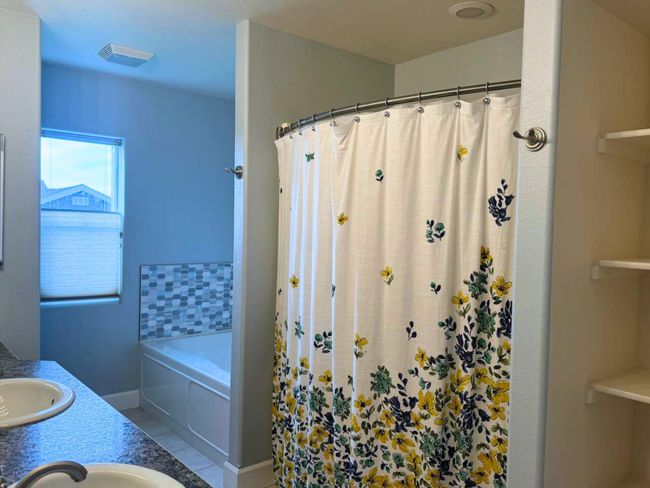 Bathroom featuring vanity, separate shower and tub, and tile patterned flooring | Image 28
