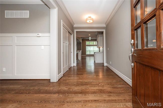 Front door and entryway featuring, dark wood-style floors and mahogany front door | Image 5