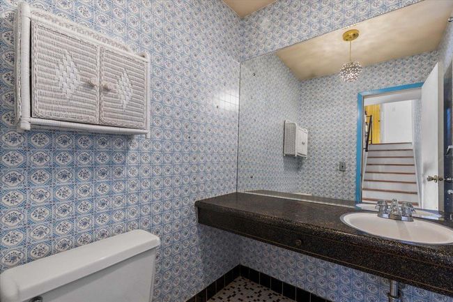 Bathroom with toilet and a sink | Image 14