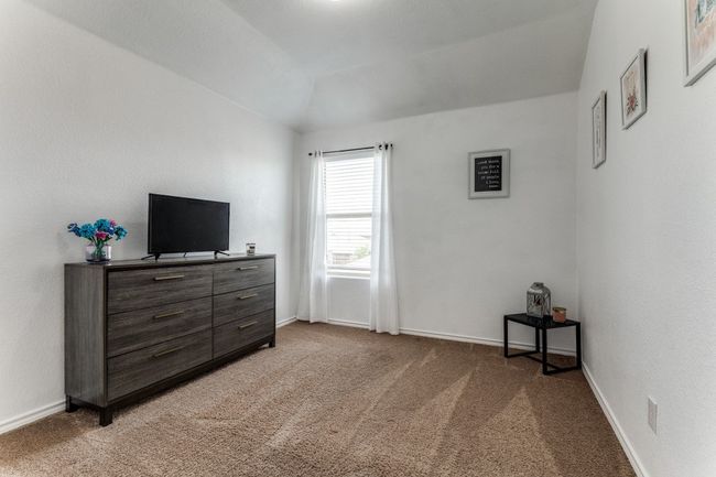 Bedroom featuring light colored carpet and vaulted ceiling | Image 19