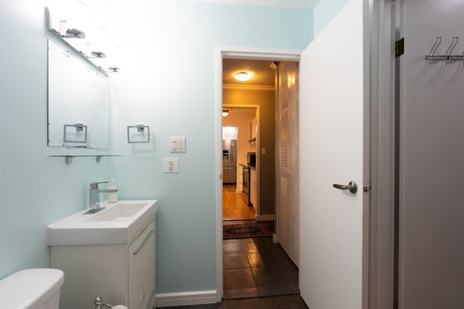 Half bath with toilet, tile patterned floors, and vanity | Image 20