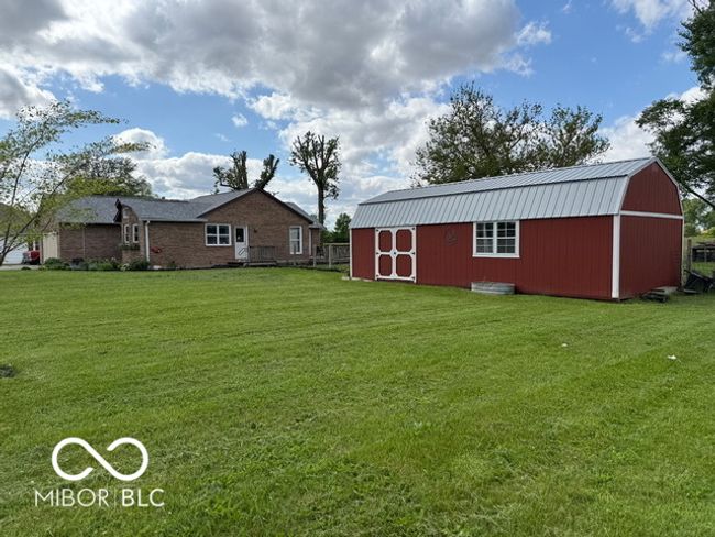 view of green lawn featuring an outdoor structure | Image 4