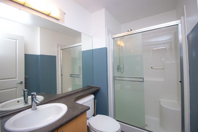 Bathroom with a stall shower and vanity | Image 12