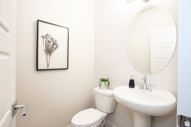 Bathroom featuring toilet, baseboards, and a sink | Image 21
