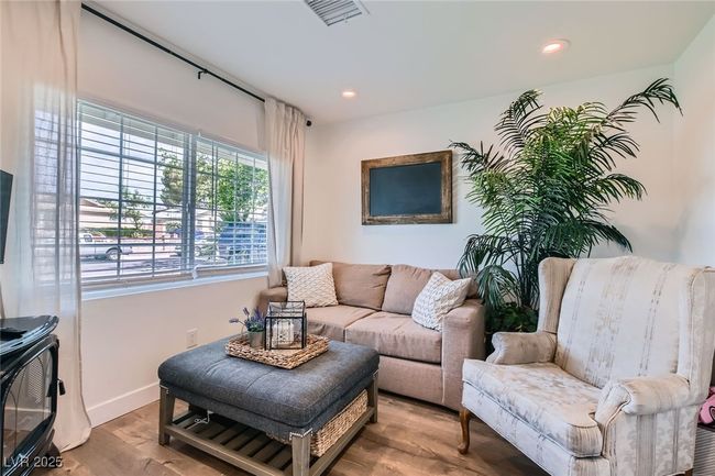 Living area with wood finished floors, baseboards, and recessed lighting | Image 10